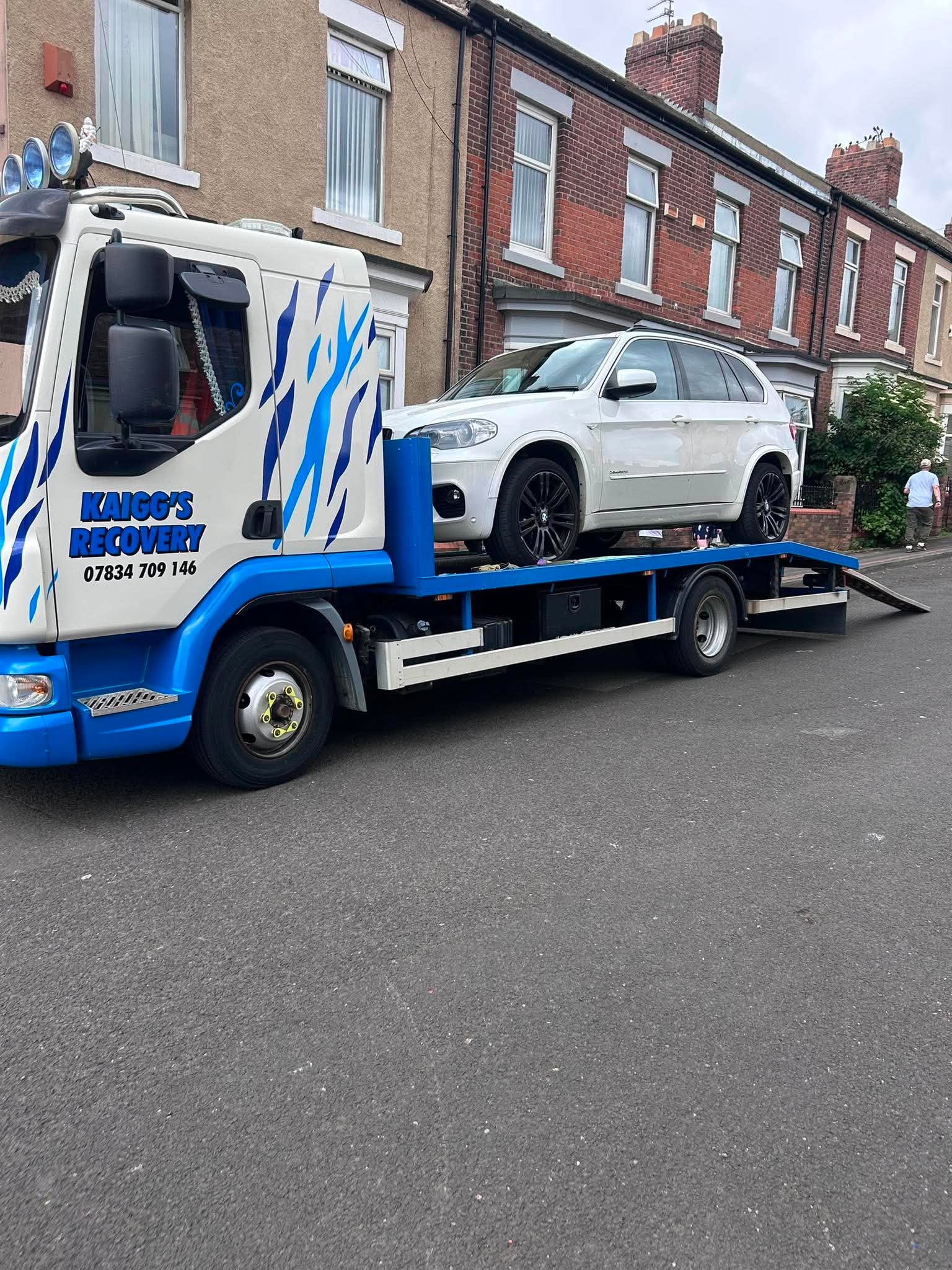 Kaigg's Recovery flatbed truck loaded with a BMW X5