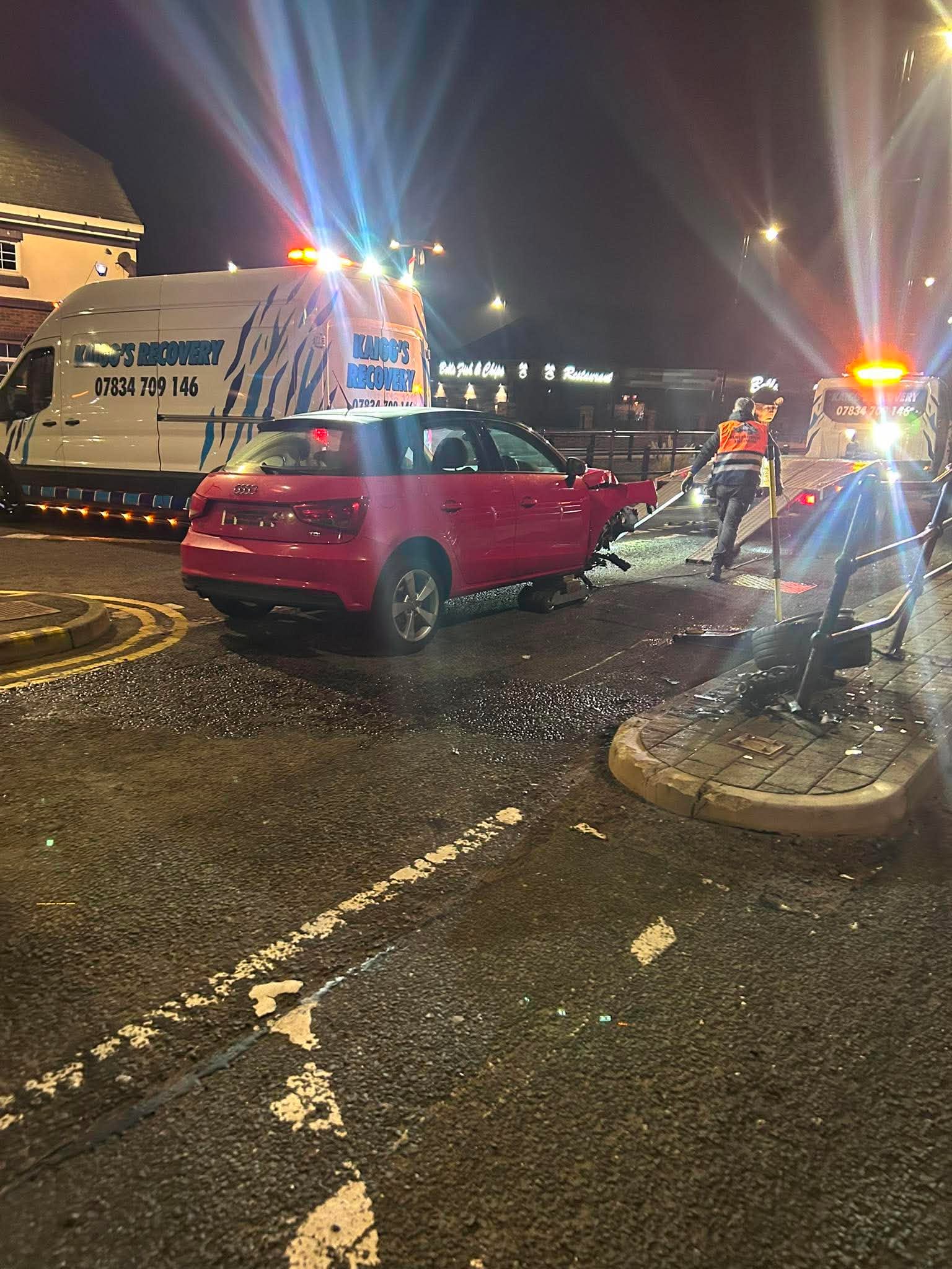 Kaigg's Recovery van and truck recovering a car at night